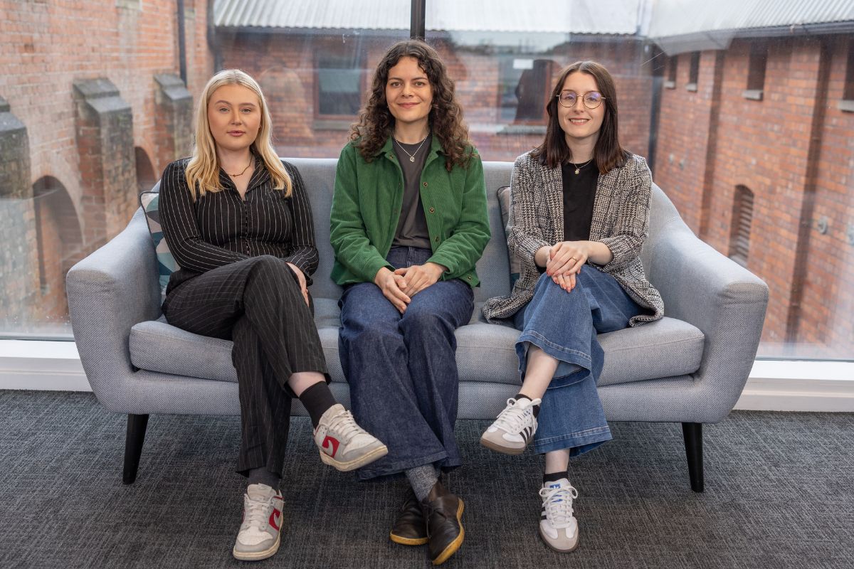 holly, alice and lois sat on a sofa